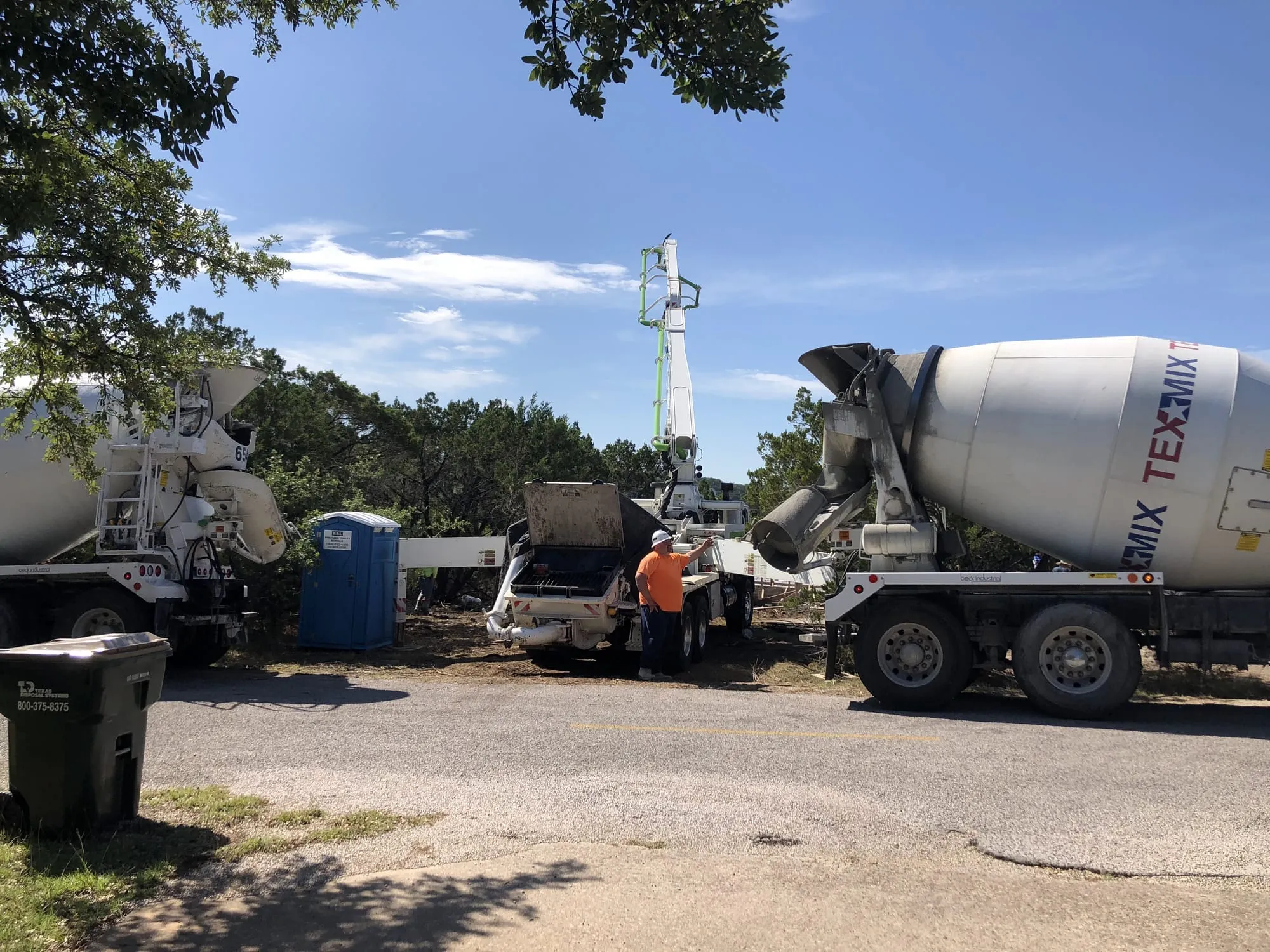 Foundation pour, Austin A concrete pour under way on a Central Texas site, two mixer trucks feeding the placement