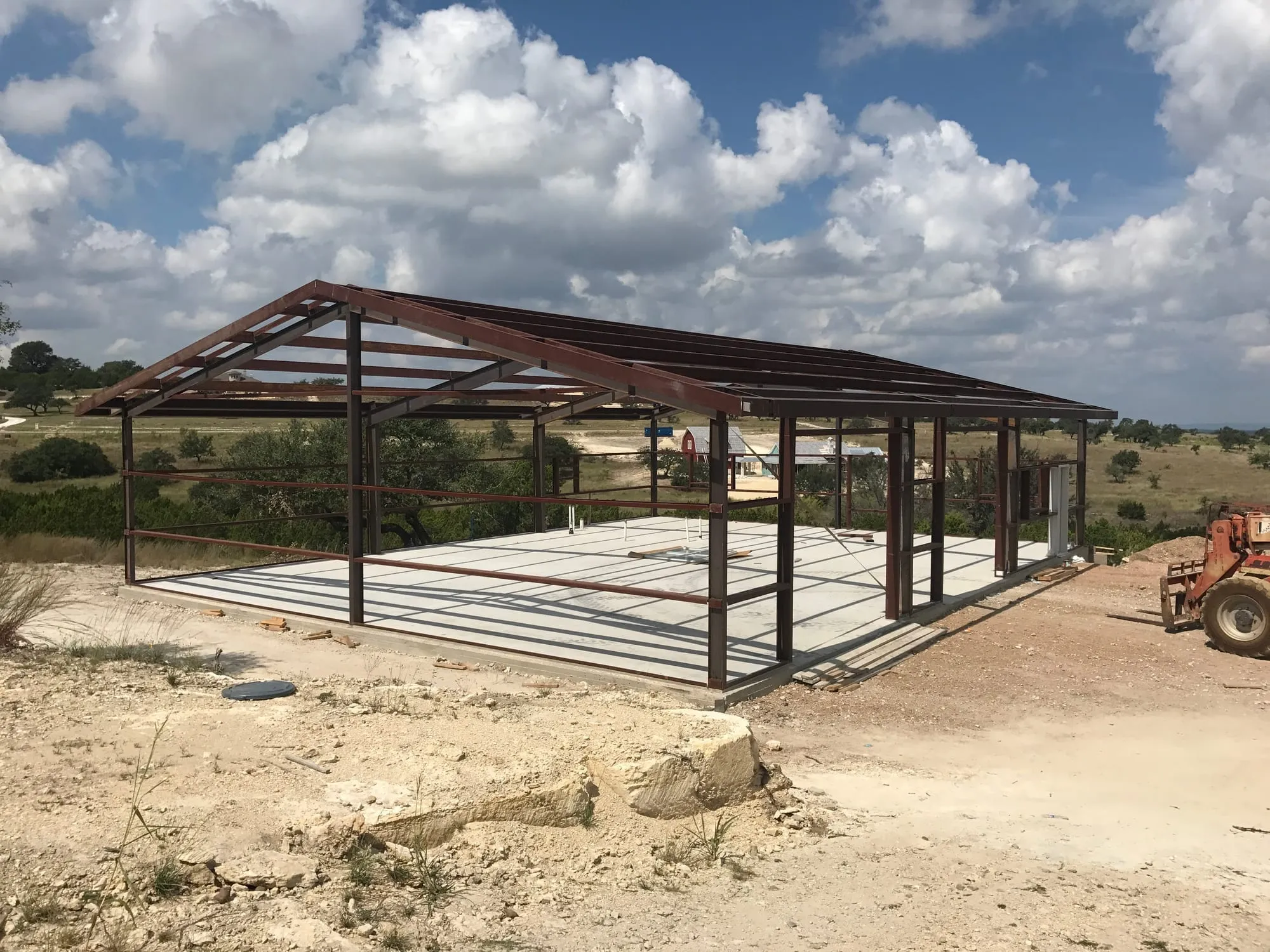 Steel frame over a self-performed slab, Austin A steel frame standing over a finished slab on a Central Texas site