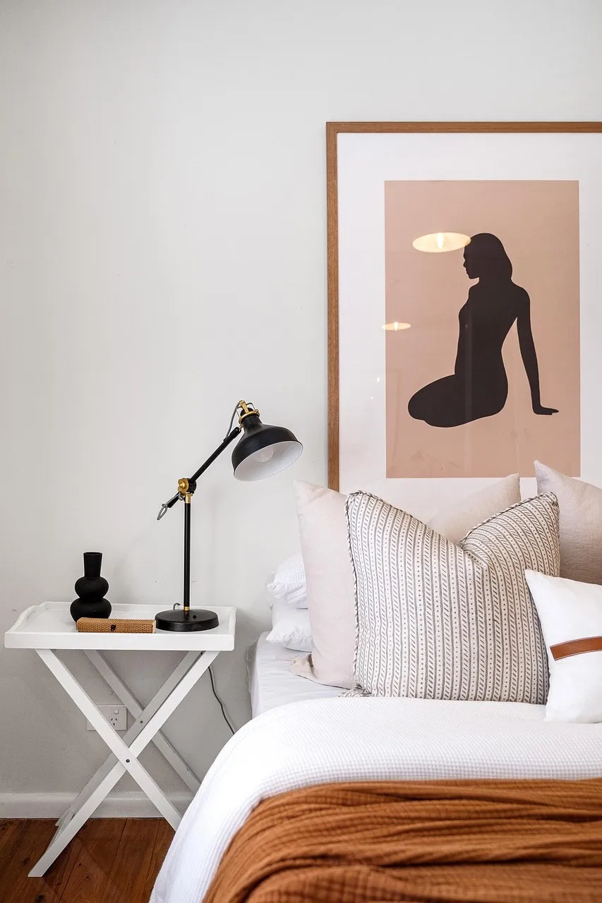 Bedroom with a framed print and bedside lamp