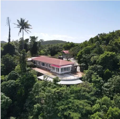 Hillside building Red-roofed building on a wooded hillside