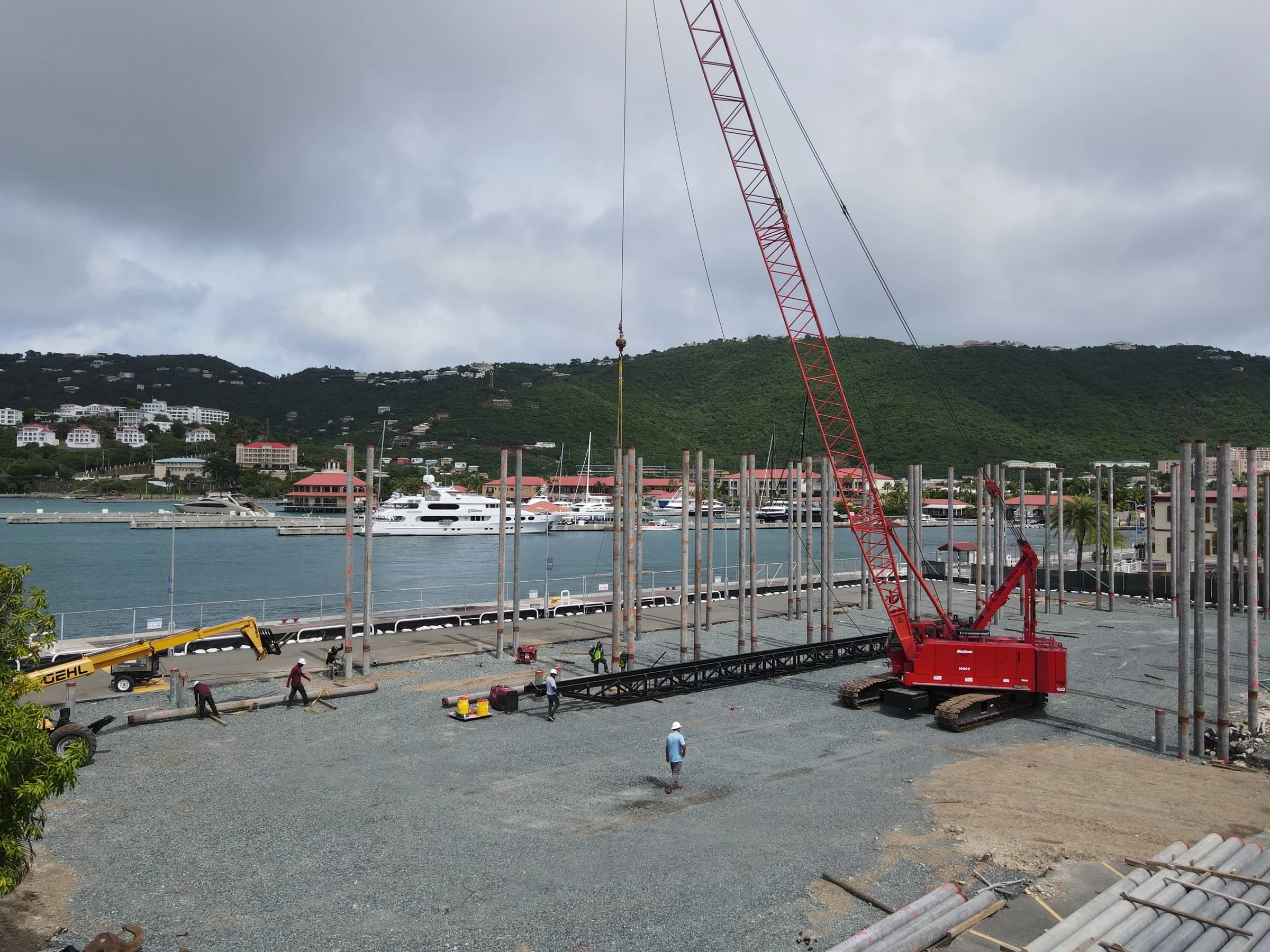 Waterfront pile driving Crawler crane driving steel piles on a waterfront site