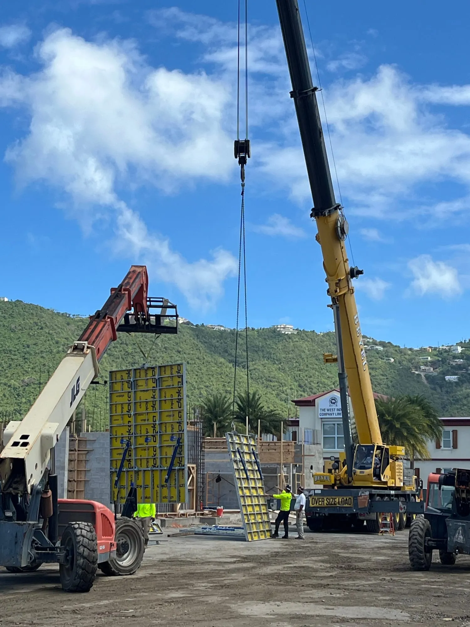 A crane lifting a formwork panel into place on the concrete superstructure