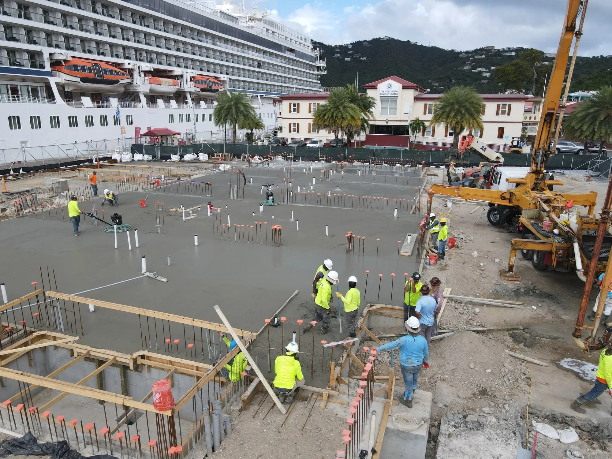 A self-performed slab pour on the waterfront site, a cruise ship berthed at the WICO dock behind it